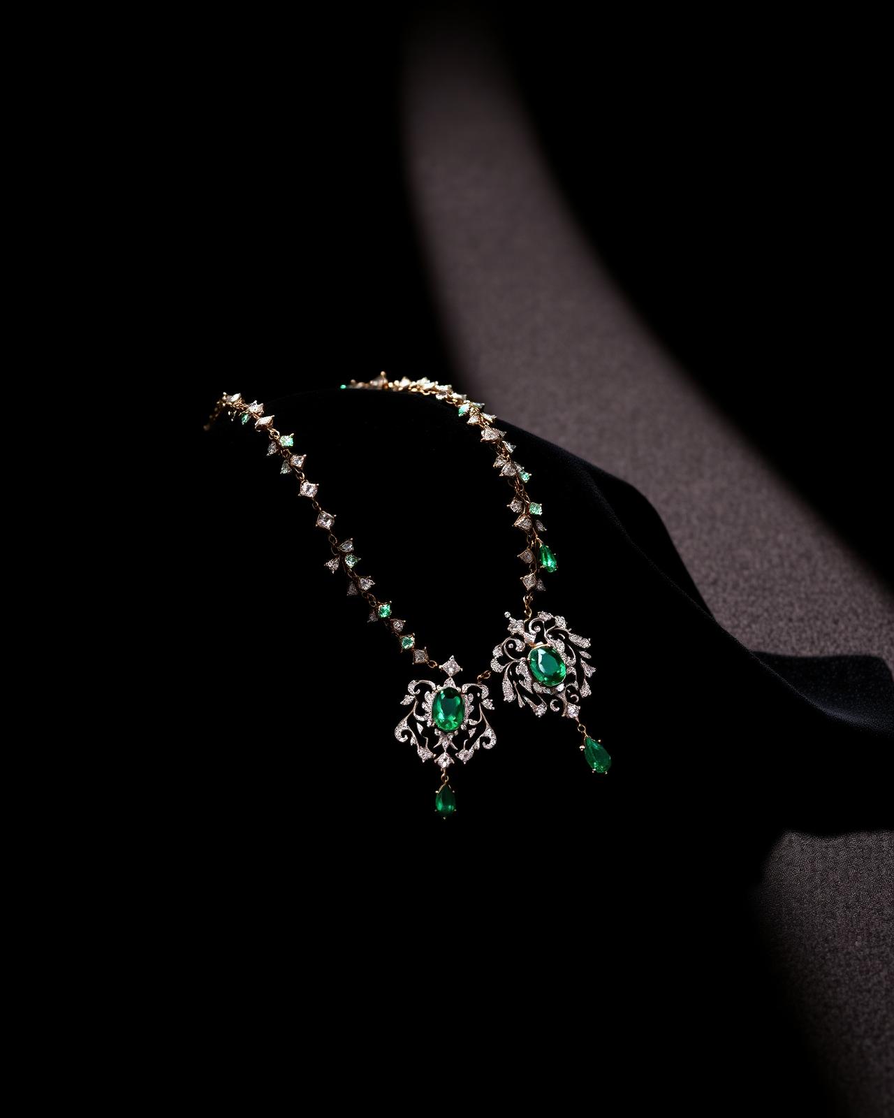 Diamond and emerald necklace on black velvet